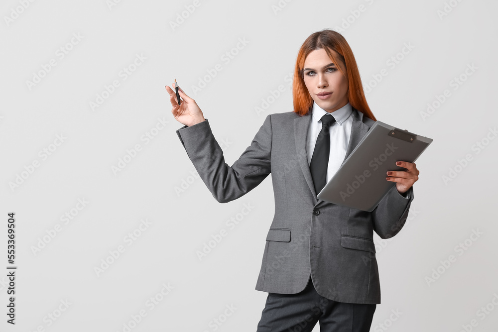 Wall mural beautiful transgender secretary with clipboard on grey background