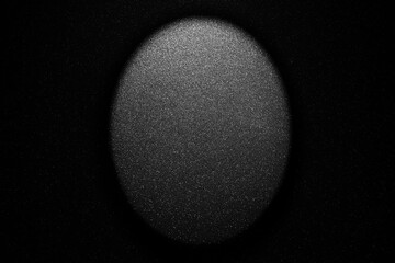 Black texture with white speckles and backlight as background