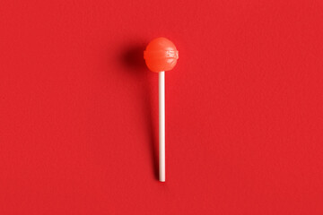 Sweet lollipop on red background