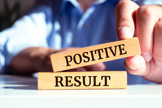 Wooden blocks with words 'Positive Result'.