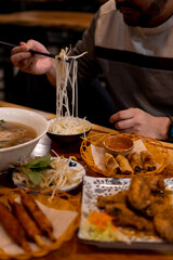 A spread of Vietnamese food including a hot bowl of pho
