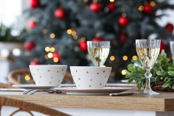 Christmas table setting with glasses of champagne in kitchen, closeup