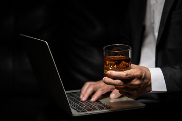 Closeup businessmen holding a glass of whiskey