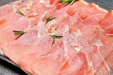 Slices of tasty ham with rosemary, closeup
