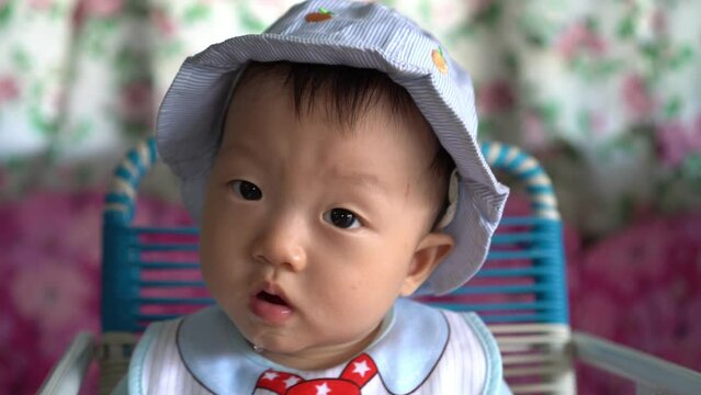 Infant drop the droll while sit at baby chair