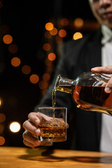 Barman pouring whiskey whiskey glass beautiful night