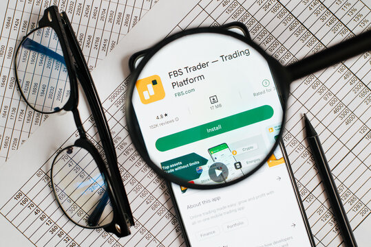 FBS trader financial mobile application in online store on smartphone in workplace, investment and trading. Top view, view through magnifying glass. Astana, Kazakhstan 12.12.2022