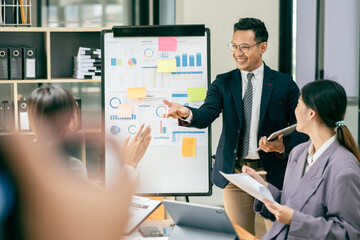 Group of asian business people working, discussing new projects together, having fun at the office.
