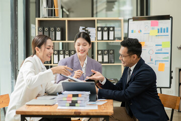 Group of asian business people working, discussing new projects together, having fun at the office.