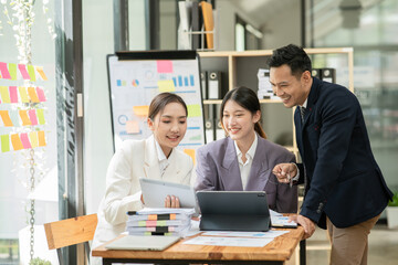 Group of asian business people working, discussing new projects together, having fun at the office.