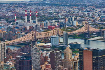 Bridge crossing over into New York City from above in detail with industrial buildings