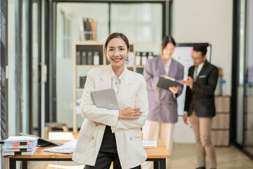 Group of asian business people working, discussing new projects together, having fun at the office.