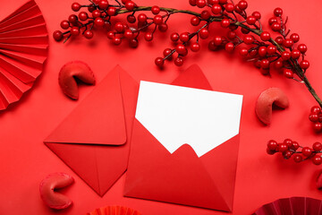 Envelopes with blank card, fortune cookies and Chinese symbols on red background. New Year celebration