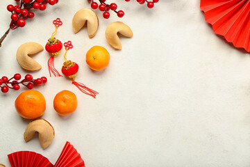 Frame made of fortune cookies, mandarins and Chinese symbols on white background. New Year...
