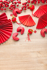 Red fortune cookies and Chinese symbols on wooden background. New Year celebration