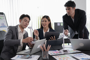 Group of asian business people working, discussing new projects together, having fun at the office.