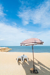 patio outdoor table and chair on beach with sea beach background