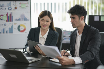 Group of asian business people working, discussing new projects together, having fun at the office.