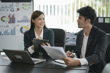 Group of asian business people working, discussing new projects together, having fun at the office.