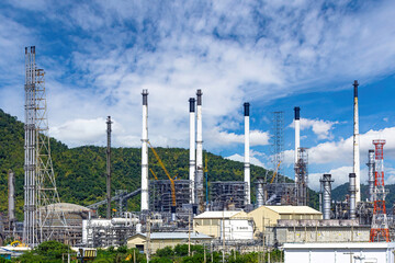 Oil refinery tower in petrochemical industry plant with cloudy sky.