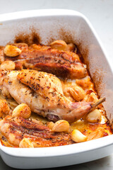 baked rabbit leg with garlic and bacon