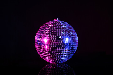 Shiny disco ball on black background