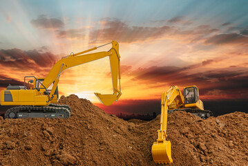Crawler Excavator is digging in the construction site ,on a sunset background .