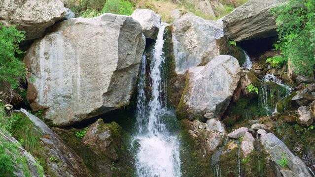 A waterfall running down in the mountains. Slow motion video, 4k. Arroyo el Molino, Merlo, San Luis, Argentina.
