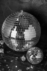 Disco balls with confetti on dark background