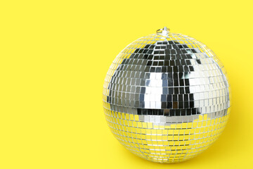 Disco ball on yellow background