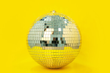 Disco ball on yellow background