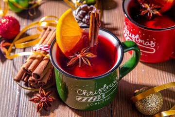 Christmas winter mulled wine drink. Classic style mulled red wine cocktail with orange slice,...