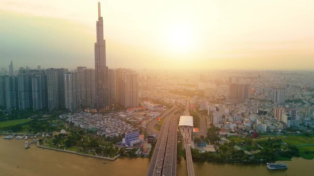Aerial view of Landmark 81 skyscraper and Ho Chi Minh city skyline in sunset and moving traffic on street. Landscape and business concept