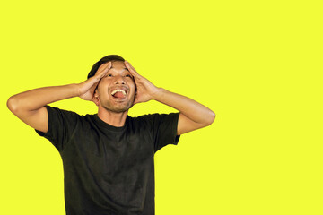 A frustrated man with a yellow background