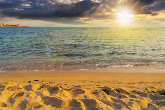 summer vacation background at the sea. clear water and sandy beach in evening light. relax and recreation season at sunset