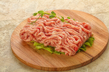 Raw minced pork meat over board