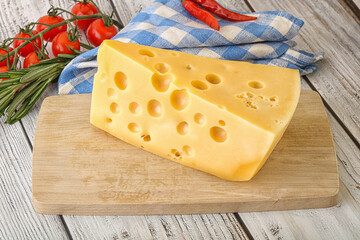 Maasdam cheese piece over board