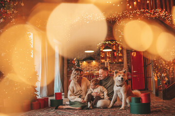 Candid authentic happy family during wintertime together enjoying holidays with dog at Xmas