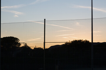 landscape at sunset with sports facilities and full moon in the background in clear sky