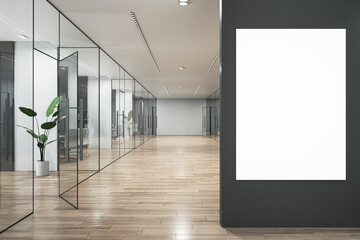 Modern glass office corridor with empty white mock up poster on dark wall, furniture and wooden flooring. 3D Rendering.