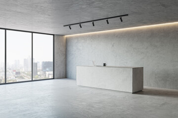 Perspective view on spacious loft style hall concrete reception desk with laptop and tea mug and...