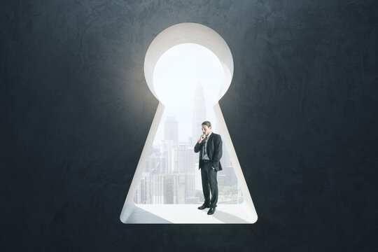 Abstract image of thoughtful businessman standing in keyhole opening and looking into the distance on blurry city background. Vision, future and think concept.