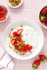 Yogurt with strawberry. Plain white greek yogurt with fresh berries and granola. Healthy food, breakfast. Top view