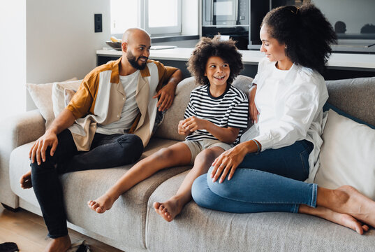 African american family sitting on sofa at home
