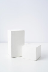 A minimalistic scene of a gypsum podium on white background, for natural cosmetics