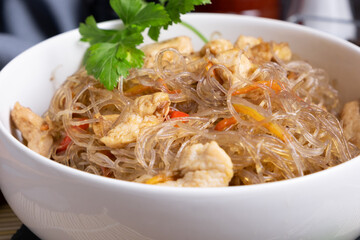Glass noodles from green funchosa beans with chicken. A dish of Chinese cuisine.