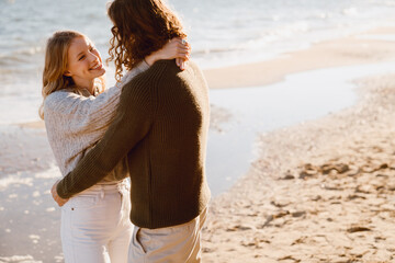 Beautiful couple cuddling while spending time together at the beach