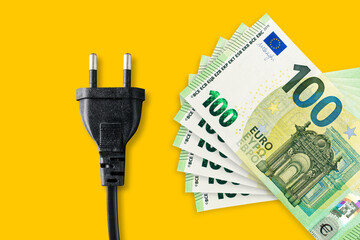 Euro banknotes on a yellow background. Energy crisis and expensive electricity, gas, oil price. Big...