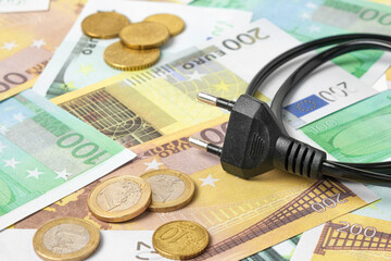 Power plug on Euro Banknotes Background. Increasing Consumption. Cost of Electricity and Expensive Energy Concept. Price Hike. Heating Crisis. Utility Bill Saving, Conservation. Annually Inflation