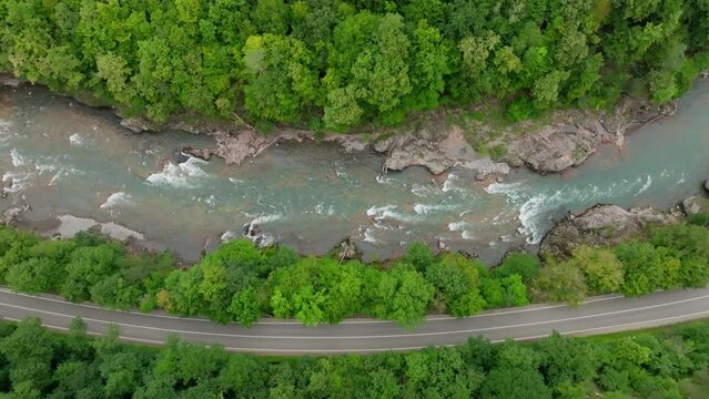 Aerial view of Mountain river and road. Flying over a mountain gorge